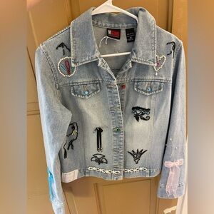 Jean jacket with hand sewn design with beads, bows, and pearls